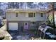 Two-story home featuring a gray painted brick exterior, one car garage, and a purple back door at 1834 Buckeye Sw St, Atlanta, GA 30310