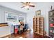 Bright bedroom featuring hardwood floors, a ceiling fan, and built-in shelving at 1834 Buckeye Sw St, Atlanta, GA 30310