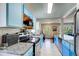 Modern kitchen featuring unique blue cabinetry, granite countertops, and stainless steel appliances at 1834 Buckeye Sw St, Atlanta, GA 30310