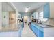 Bright kitchen with blue cabinets, granite countertops, stainless steel appliances, and white subway tile at 1834 Buckeye Sw St, Atlanta, GA 30310