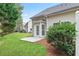 Exterior view of backyard, featuring a small patio area and well-manicured lawn at 184 Darbys Crossing Ct, Hiram, GA 30141