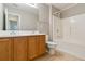 Bathroom with double vanity, oak cabinets and a bathtub with shower at 184 Darbys Crossing Ct, Hiram, GA 30141