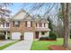 Charming townhome with brick accents, red shutters, attached garage, and well-maintained front yard at 184 Darbys Crossing Ct, Hiram, GA 30141