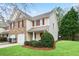 Two-story home boasts a well-kept lawn and an attached one-car garage at 184 Darbys Crossing Ct, Hiram, GA 30141