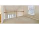 Second story loft area with carpet and a railing overlooking the living room at 184 Darbys Crossing Ct, Hiram, GA 30141