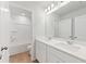 Bright bathroom boasts a double sink vanity, large mirror, and shower-tub combo at 7164 Brushwood Bend (Lot 111), Lithonia, GA 30058