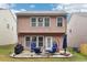 Back exterior featuring a patio with outdoor furniture, a grill, and a grassy lawn at 7717 Bellmist Dr, Fairburn, GA 30213