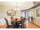 Classic dining room featuring hardwood floors and a decorative chandelier at 7717 Bellmist Dr, Fairburn, GA 30213