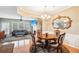 Open dining room with hardwood floors and decorative lighting at 7717 Bellmist Dr, Fairburn, GA 30213