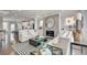 An open living room featuring a fireplace, comfortable seating, hardwood floors, and ample natural light at 1733 Lansmere Sw St, Marietta, GA 30008