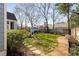 Grassy backyard with a stone pathway and blue shed in the distance at 420 Rammel Oaks Dr, Avondale Estates, GA 30002