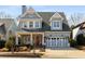 Charming home featuring a red front door, blue garage door, and lovely landscaping at 420 Rammel Oaks Dr, Avondale Estates, GA 30002