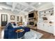 Inviting living room with coffered ceilings, a stone fireplace, and built-in bookshelves at 420 Rammel Oaks Dr, Avondale Estates, GA 30002