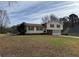 Traditional two-story home featuring red shutters, attached two-car garage, and a spacious front yard with mature trees at 4660 Cedar Brook Se Dr, Conyers, GA 30094