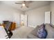 This bedroom features a ceiling fan, white trim, a gray carpet, and gray walls at 475 Rowes Cir, Alpharetta, GA 30009