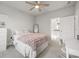 Bedroom with a view into the ensuite bathroom, featuring a bed, desk, and carpeted floors at 475 Rowes Cir, Alpharetta, GA 30009