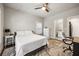 Bedroom with a view into the ensuite bathroom, featuring a ceiling fan and a patterned rug on hardwood floors at 475 Rowes Cir, Alpharetta, GA 30009