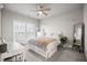 Well-lit bedroom featuring a bed, desk, and a window with blinds providing views to the backyard at 475 Rowes Cir, Alpharetta, GA 30009