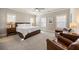 Spacious primary bedroom with large windows, neutral paint, ceiling fan, and two chairs for relaxing at 475 Rowes Cir, Alpharetta, GA 30009