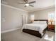 Bright and airy primary bedroom featuring a ceiling fan, natural light, and a king-size bed at 475 Rowes Cir, Alpharetta, GA 30009