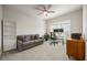 This bedroom features a ceiling fan, a large window, a couch, and a white bookshelf at 475 Rowes Cir, Alpharetta, GA 30009