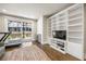 A bonus room featuring a wall-to-wall shelving unit, a treadmill, and a sliding glass door to the backyard at 475 Rowes Cir, Alpharetta, GA 30009