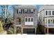 Charming brown brick two-story home with a private garage and a quaint arched balcony at 475 Rowes Cir, Alpharetta, GA 30009