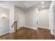 Hallway with hardwood floors leads to a staircase and an elevator with recessed lighting at 475 Rowes Cir, Alpharetta, GA 30009