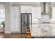 Contemporary kitchen with a stainless steel refrigerator, a gray island, and sleek cabinets at 475 Rowes Cir, Alpharetta, GA 30009