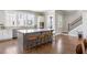 Open-concept kitchen boasts a large center island with bar stool seating and hardwood floors at 475 Rowes Cir, Alpharetta, GA 30009