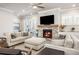 Comfortable living room with a fireplace, plush seating, and natural light at 475 Rowes Cir, Alpharetta, GA 30009