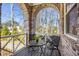 This porch has an arched brick ceiling and a decorative metal railing at 475 Rowes Cir, Alpharetta, GA 30009