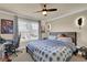 Nicely decorated bedroom with a ceiling fan, neutral colored walls, plush carpet, and natural lighting at 511 Wagon Hill Ln, Sugar Hill, GA 30518