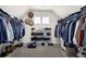 Organized walk-in closet with ample shelving, hanging space, and a window for natural light at 511 Wagon Hill Ln, Sugar Hill, GA 30518