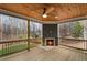 Covered back porch with wood ceiling, fan, outdoor fireplace and a view of the backyard at 331 Terrell Sw Dr, Marietta, GA 30064