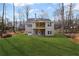 View of a large backyard with plush green grass and an elegant two-story home featuring a spacious, covered back porch at 331 Terrell Sw Dr, Marietta, GA 30064