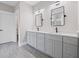 A bathroom with double sinks, sleek fixtures, gray cabinets, white quartz countertops, and modern lighting at 331 Terrell Sw Dr, Marietta, GA 30064