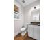 Stylish half bathroom features a granite countertop, gold faucet and white vanity at 331 Terrell Sw Dr, Marietta, GA 30064