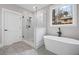 Bathroom featuring a modern soaking tub, marble shower, sleek fixtures and fixtures, and natural light at 331 Terrell Sw Dr, Marietta, GA 30064