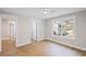 Bedroom featuring hardwood flooring, base molding, white walls, and a window overlooking the lawn at 331 Terrell Sw Dr, Marietta, GA 30064