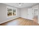 Bedroom featuring hardwood flooring, base molding, white walls, and a window overlooking the lawn at 331 Terrell Sw Dr, Marietta, GA 30064