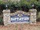 Stone community sign with the name 