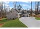 New construction home featuring board and batten siding, green grass, and a long concrete driveway at 331 Terrell Sw Dr, Marietta, GA 30064