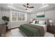This primary bedroom offers a ceiling fan, hardwood floors, a large window, and a view of the surrounding landscape at 331 Terrell Sw Dr, Marietta, GA 30064
