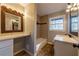 This bathroom features a tub shower and a vanity with a large mirror at 3377 Bobolink Cir, Atlanta, GA 30311