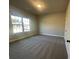 Bedroom featuring a carpeted floor, bright window, and a door at 3828 Southfield Ct, Loganville, GA 30052