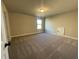 Bedroom featuring a carpeted floor, bright window, and a door at 3828 Southfield Ct, Loganville, GA 30052