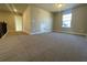 Spacious bonus room with neutral carpet, natural light, and access door at 3828 Southfield Ct, Loganville, GA 30052
