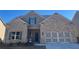 Charming brick home featuring a two-car garage, inviting front entry, and well maintained landscaping at 3828 Southfield Ct, Loganville, GA 30052