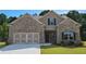 Lovely home with brick and siding, two car garage and landscaping, inviting curb appeal at 3828 Southfield Ct, Loganville, GA 30052